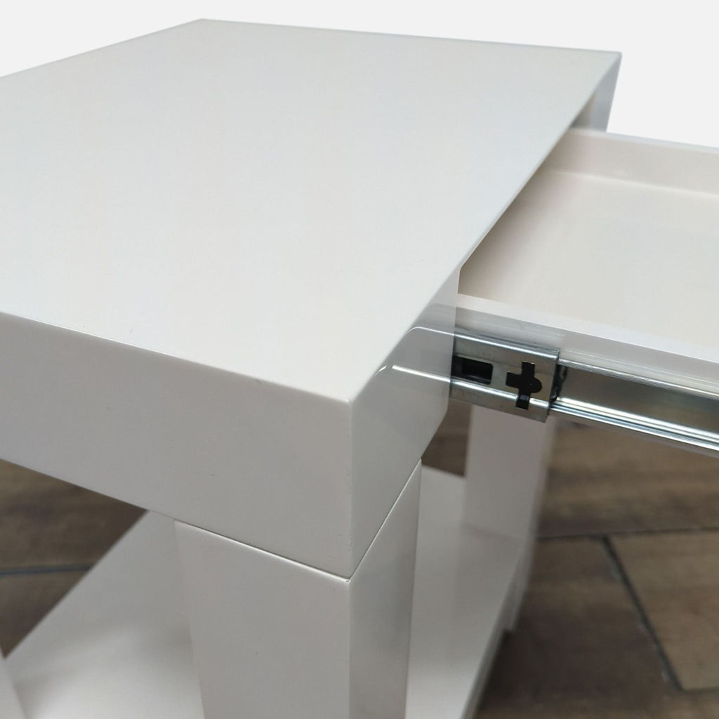 3. Close-up of the West Elm white side table’s corner, highlighting the open drawer and sleek design.
