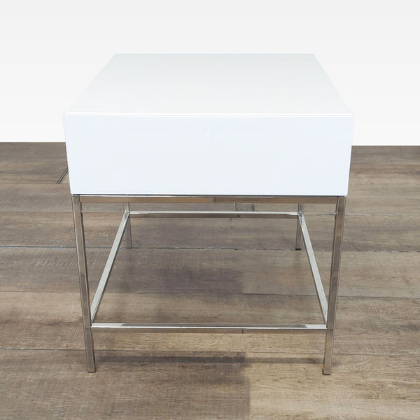 White West Elm side table with a single drawer on a sleek metal base, shown from the front.