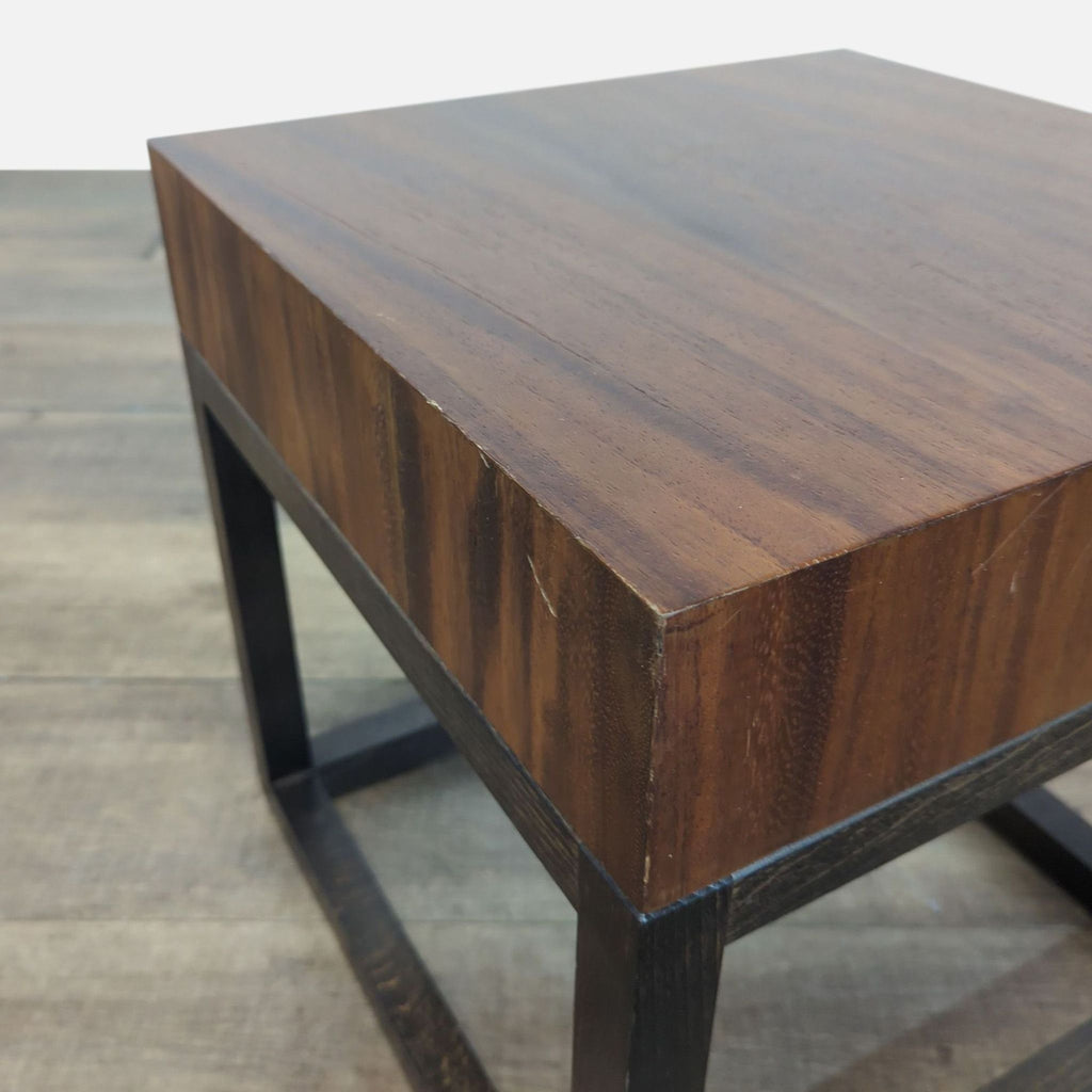 3. Angled view of Crate & Barrel square side table highlighting the thick wooden top and sleek dark legs.