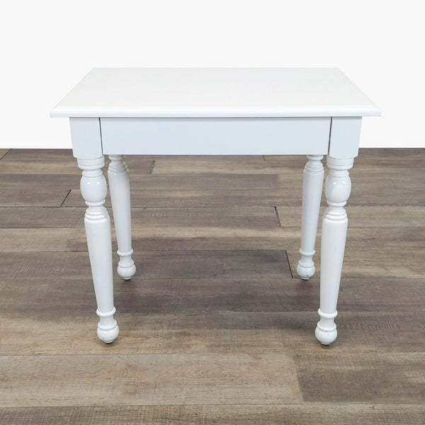 White Reperch end table with turned legs, shown on wooden flooring, category: End Table.