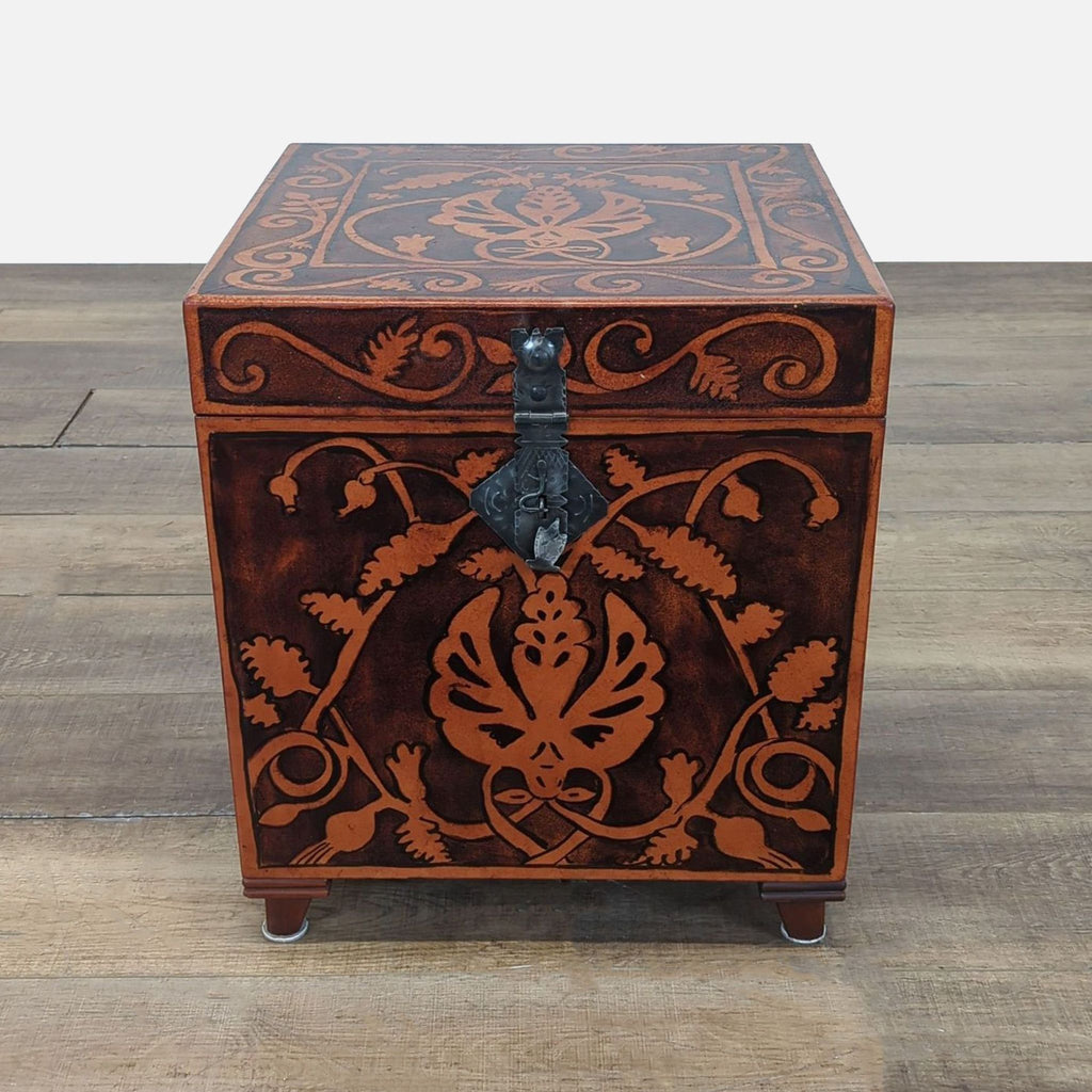 1. Ornate South Cone trunk with floral patterns on wood, metal latch, and sturdy feet, closed on wood floor.  