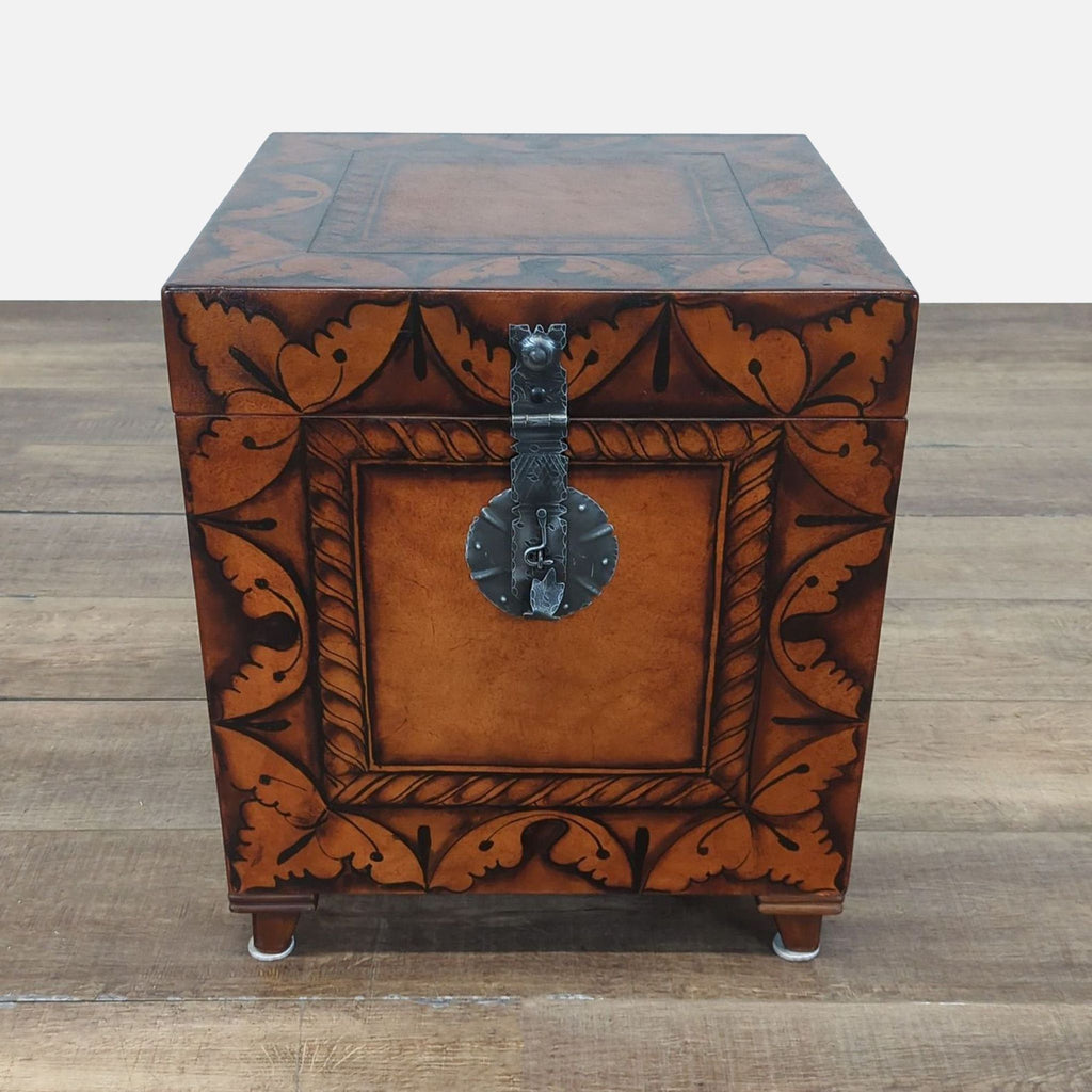 1. Ornate brown wooden trunk by South Cone with decorative leaf patterns and a metal latch on the front.