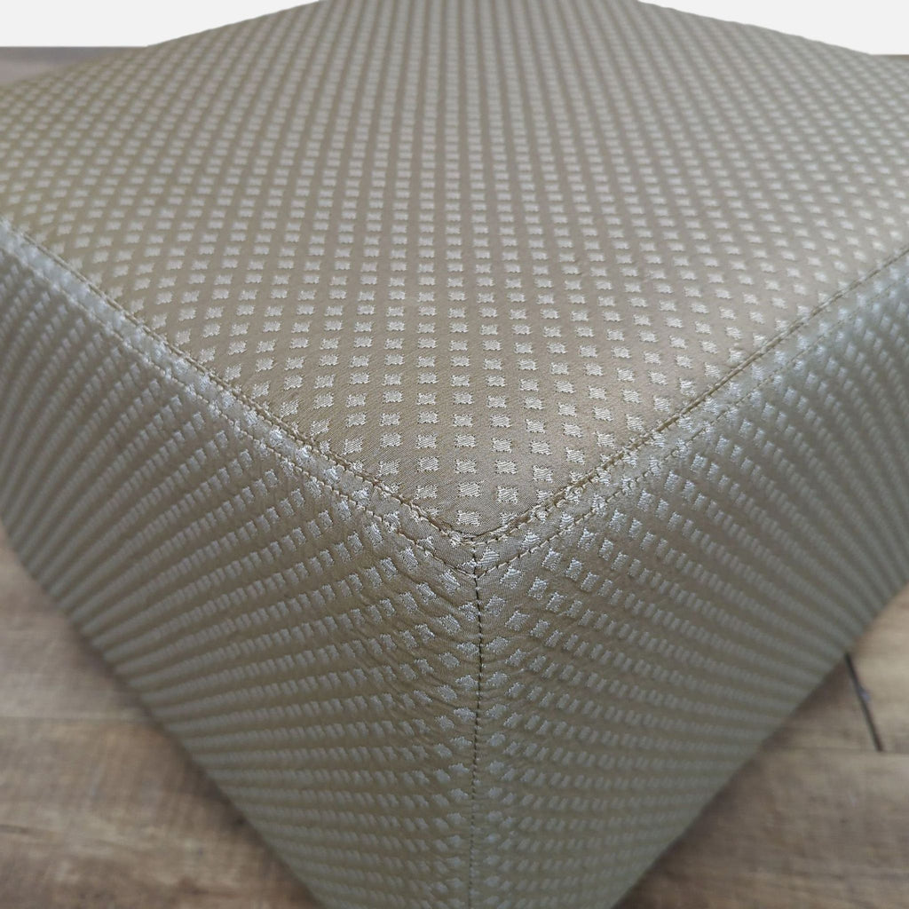 Close-up of the diamond-patterned upholstery on a Cisco Bros. ottoman, showcasing detailed stitching and texture.
