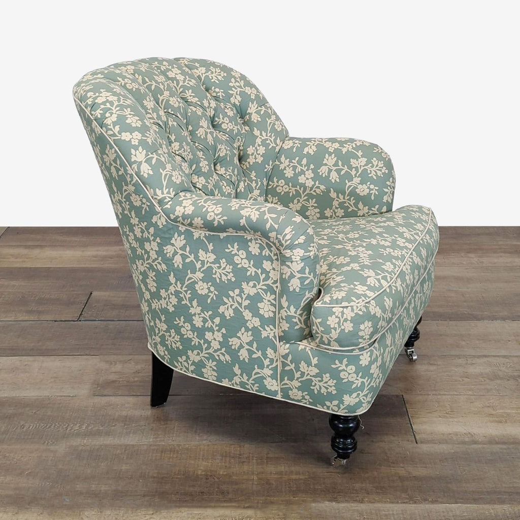 2. Side view of a Cisco Brothers lounge chair featuring floral fabric, tufted back, and wood legs on casters.