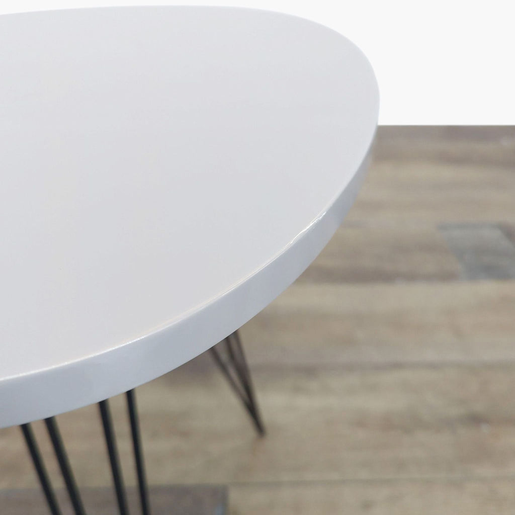 2. Close-up of the white lacquer top of a Safavieh console table with a smooth, modern finish.
