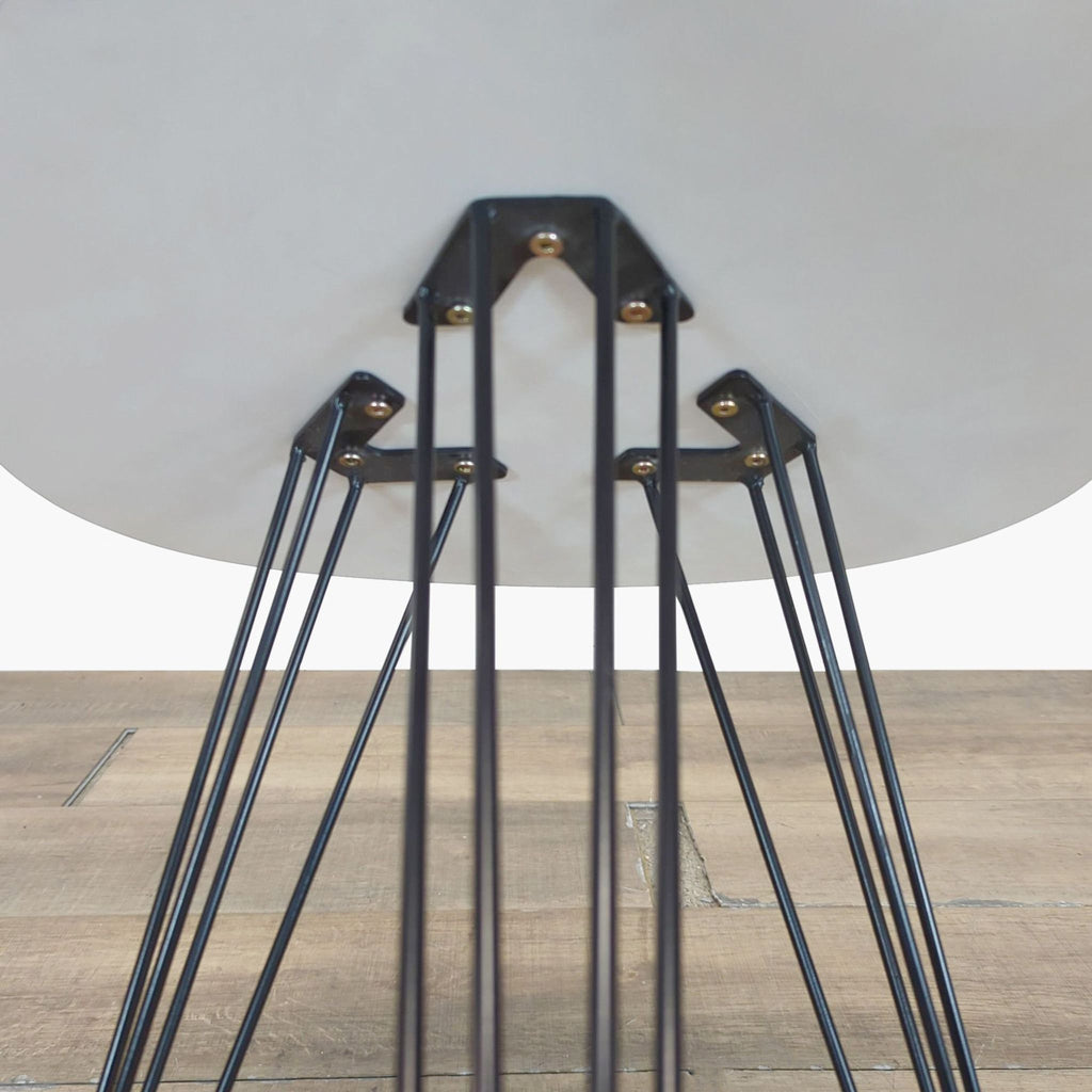 3. Underside view of Safavieh side table highlighting black iron hairpin legs securely attached to the top.