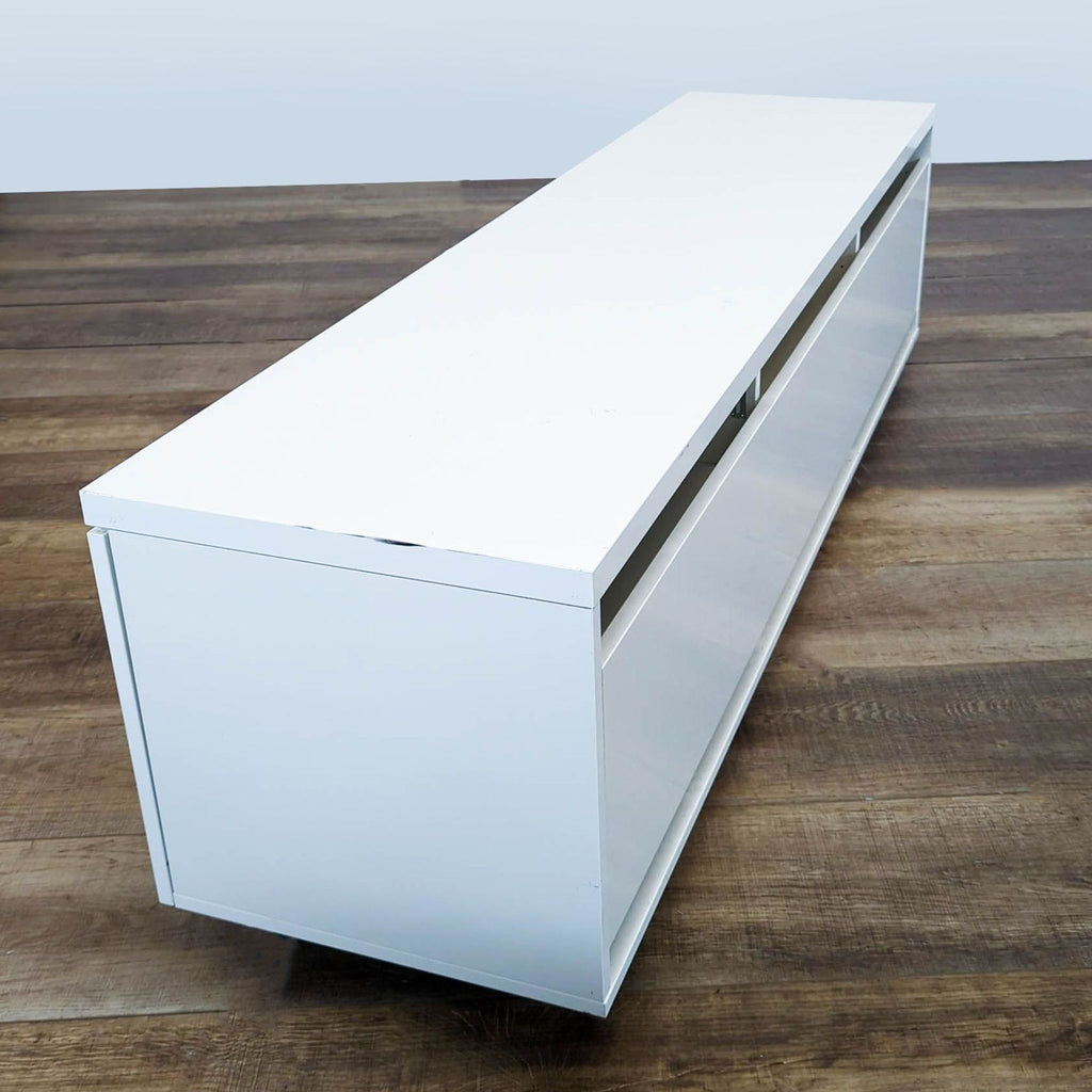 3. Angled side view of a white Reperch entertainment center with clean lines, highlighting its modern, minimal design.