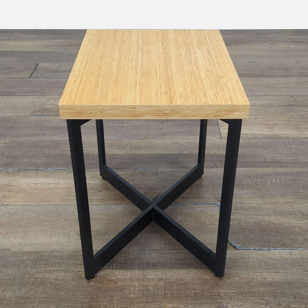 Rectangular Reperch console table featuring a bamboo-style wood top and geometric black metal legs, front view.  