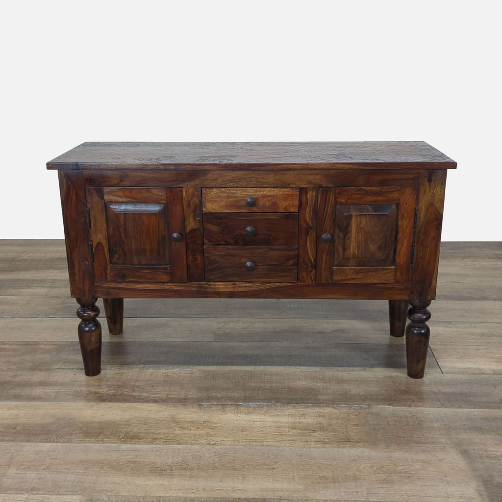 1. Dark wood Crate & Barrel sideboard with paneled doors, three central drawers, and turned legs on a wood floor.