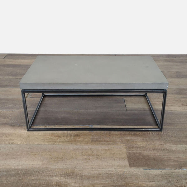 1. Structube coffee table with a concrete top and black metal frame on wooden flooring, front view.  
