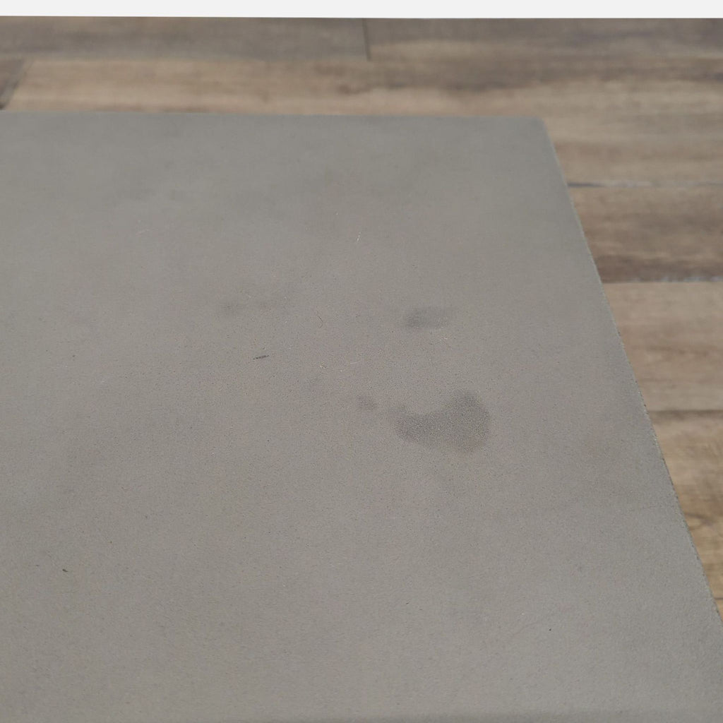 3. Top view of the Structube coffee table’s concrete surface, displaying light marks and texture.