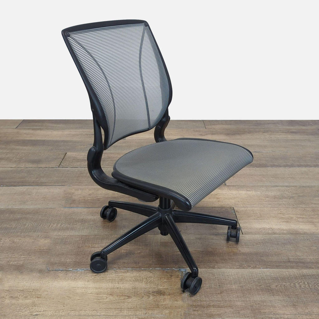 Side view of a Humanscale ergonomic chair with a contoured mesh back, mesh seat, and self-adjusting recline.  