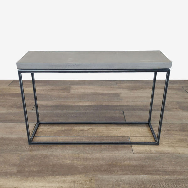 1. Structube side and console table with a concrete top and minimalist black metal frame, shown on wood floor.