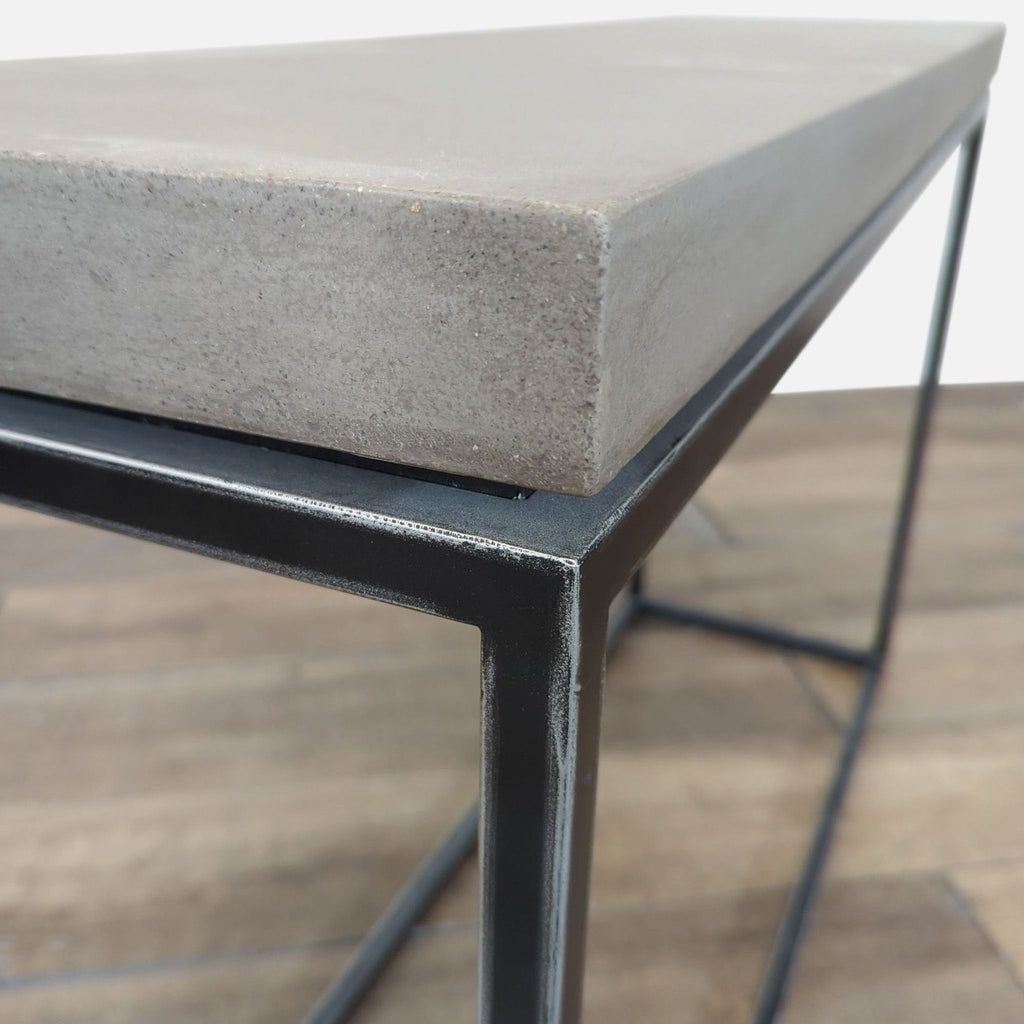 2. Close-up of Structube table corner, featuring a thick concrete top and sturdy black metal frame.