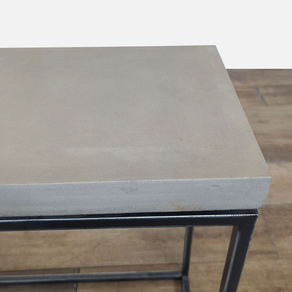3. Top view of Structube side table, highlighting the smooth concrete surface and modern metal frame below.