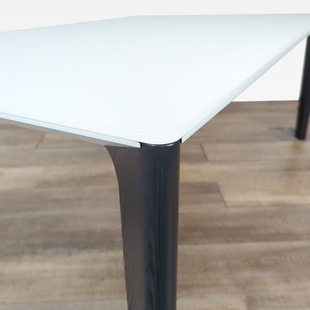 2. Close-up of Bontempi table corner, showing white scratch-resistant glass top and dark solid wood leg details.  