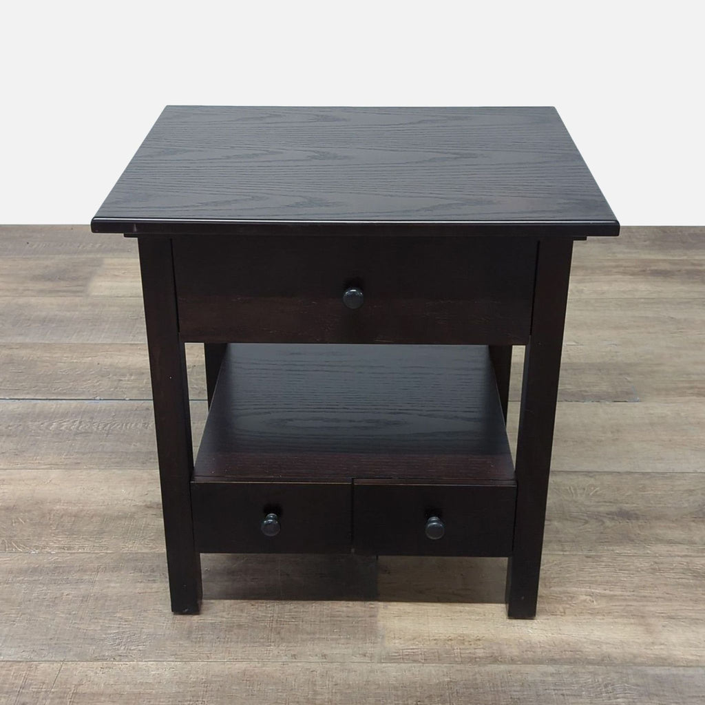1. Crate & Barrel dark wood end table with closed drawers and open shelf, shown on hardwood flooring.