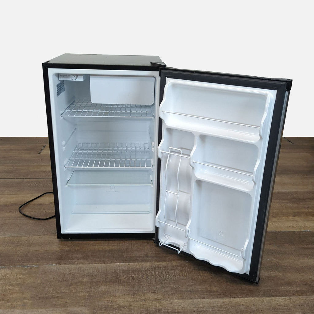 3. Interior of Kenmore compact mini fridge with open door, showing freezer, shelves, and door storage compartments.