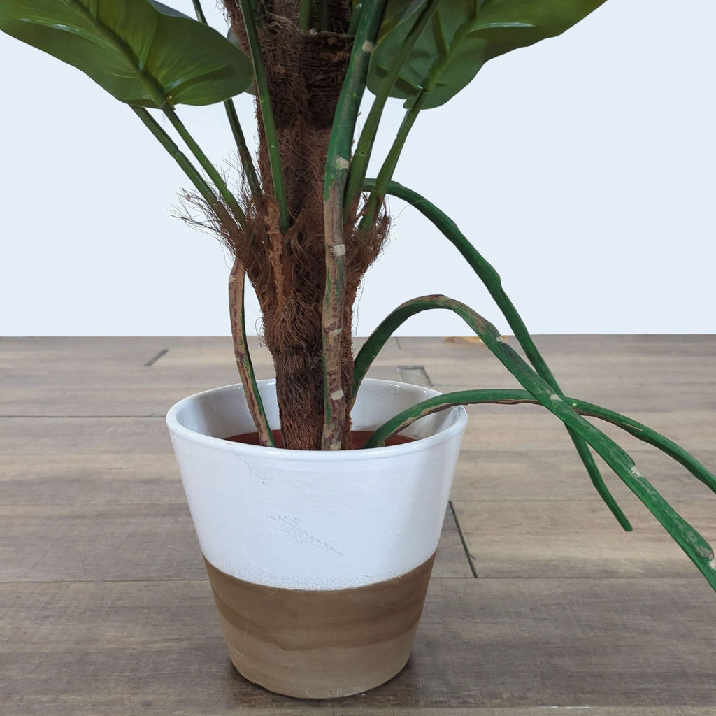 3. Lower part of Reperch artificial plant in a white and tan pot, highlighting stems and leaf details.
