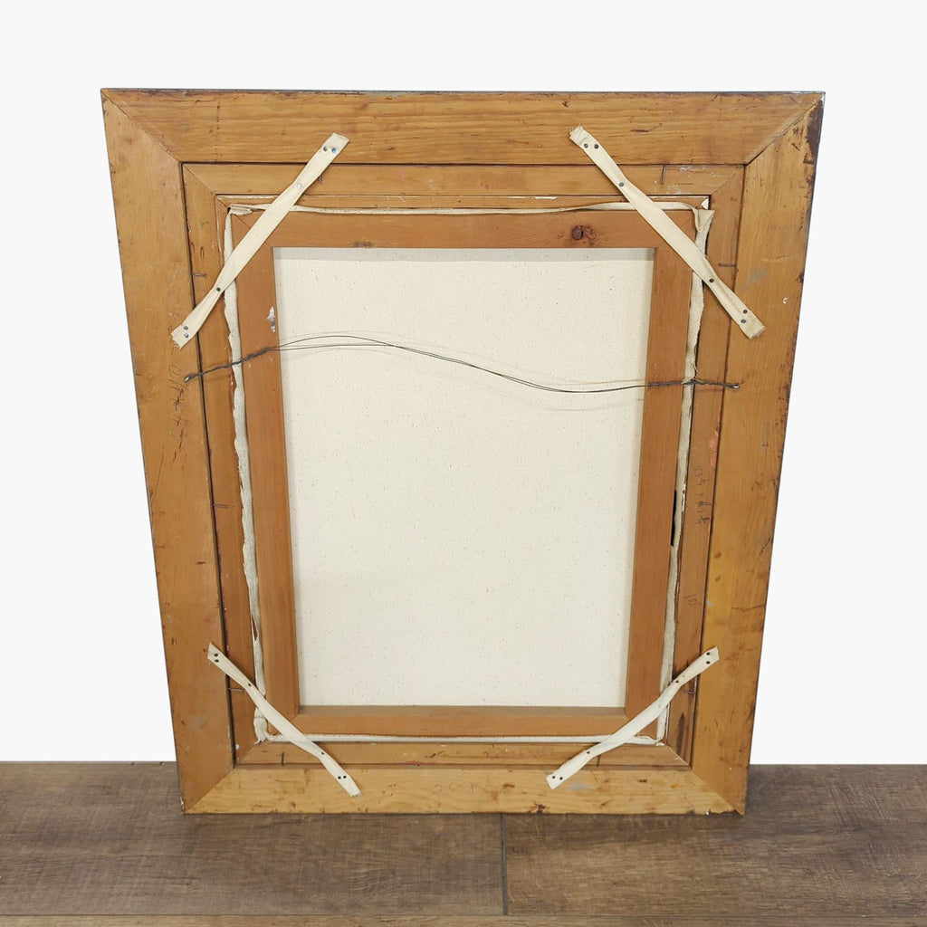 Rear view of the framed canvas print, showing the wooden frame construction and hanging wire attached.