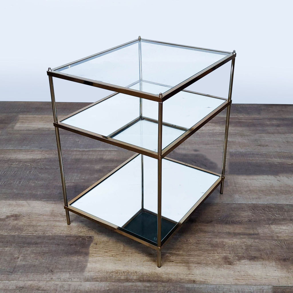 2. Gold metal Reperch console table with one glass top and two mirrored shelves, modern style.