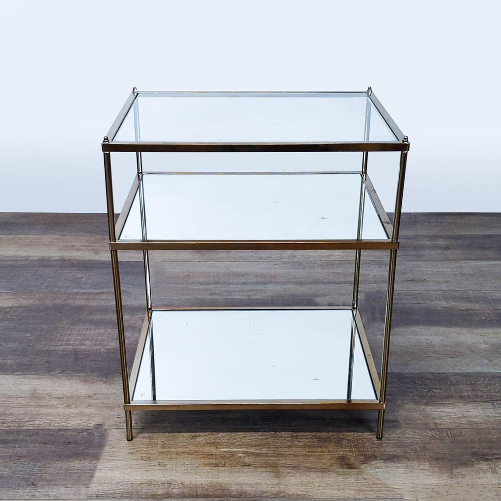1. Reperch side table with a glass top, mirrored shelves, and a gold-finished metal frame.