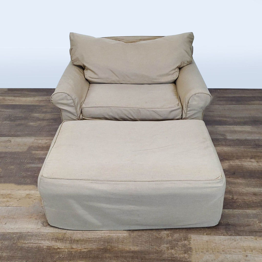 1. Reperch Bridge lounge chair and ottoman with slipcover in beige, shown on wooden flooring.