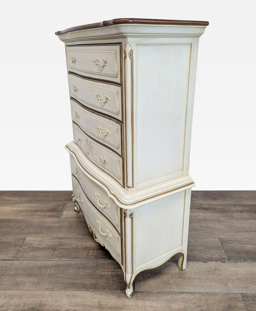 2. Side angle of a Drexel Heritage dresser with elegant curves, gold detailing, and a classic French Provincial style.
