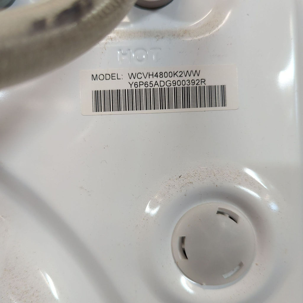 3. Close-up of the model label on a GE washer displaying “WCVH4800K2WW” and serial number.