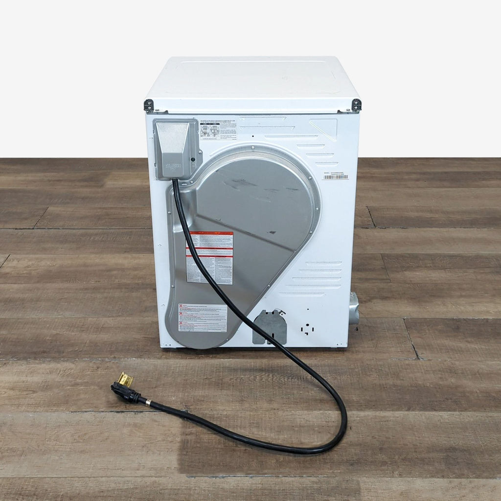 2. Rear view of the GE electric dryer showing the power cord, vent, and back panel details on a wooden floor.