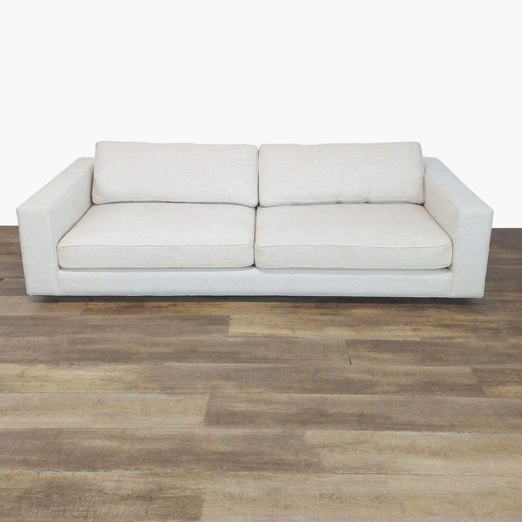 1. Reperch 3-seat sofa with neatly piped seat and back cushions and clean track arms shown on wood flooring.
