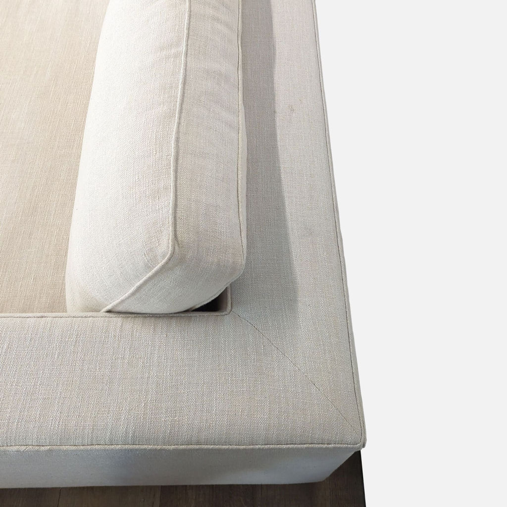 3. Top view of Reperch 3-seat sofa’s corner, featuring piped cushion and structured track arm design.