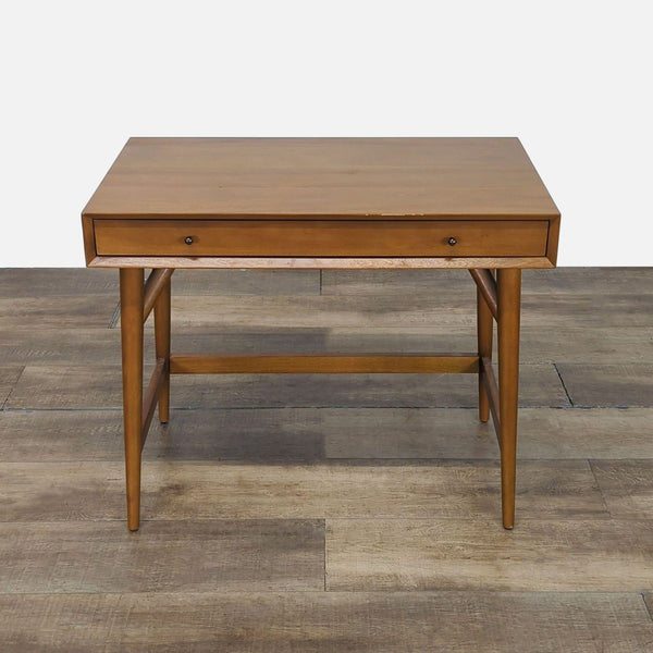 Mid-century modern wooden desk from West Elm with a single front drawer, shown on a wooden floor.  