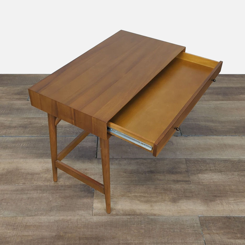 West Elm desk made of sustainably sourced wood, featuring a large, open drawer for storage.  