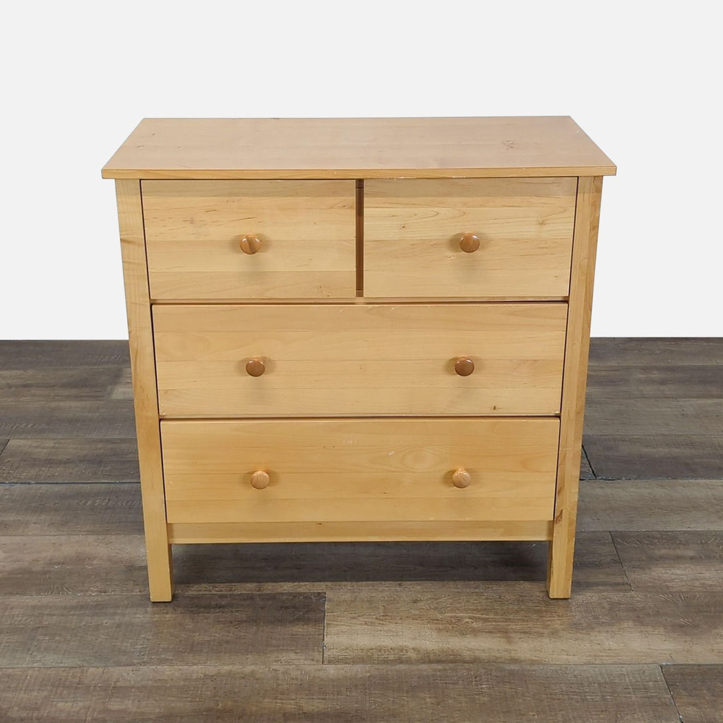 1. Light wood dresser with four drawers and round wooden knobs, shown on a wood floor, Crate and Barrel Kids.