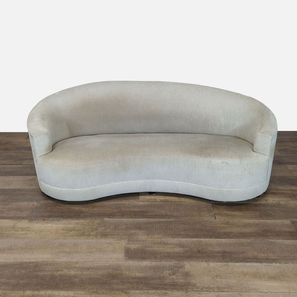 Curved modern 3-seat sofa by Crate & Barrel in light fabric, shown on a wooden floor, front view.  