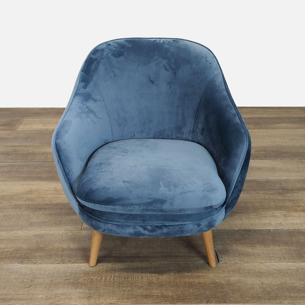 Front view of a velvet lounge chair in dust blue with wood legs by Industry West.  
