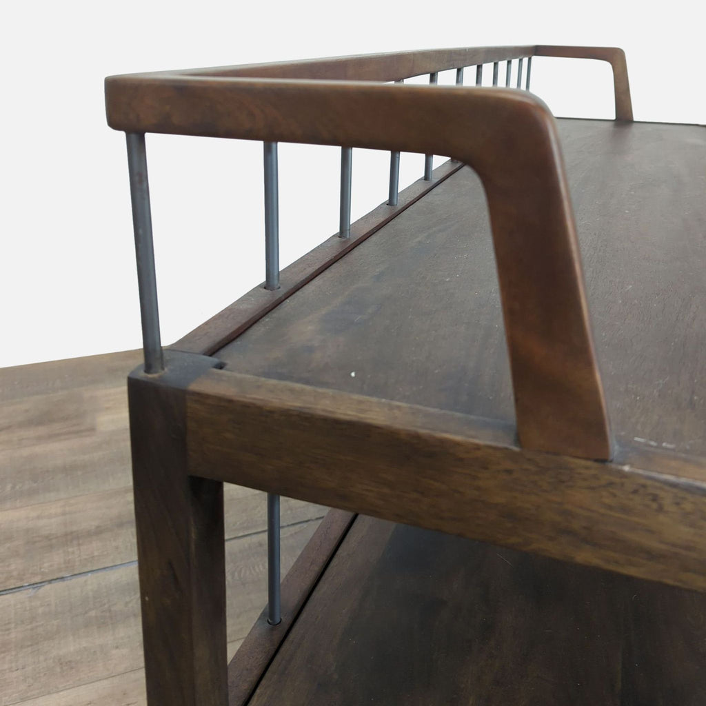 2. Close-up of console table's upper corner showing pecan-finished mango frame and sleek iron rod accents.  