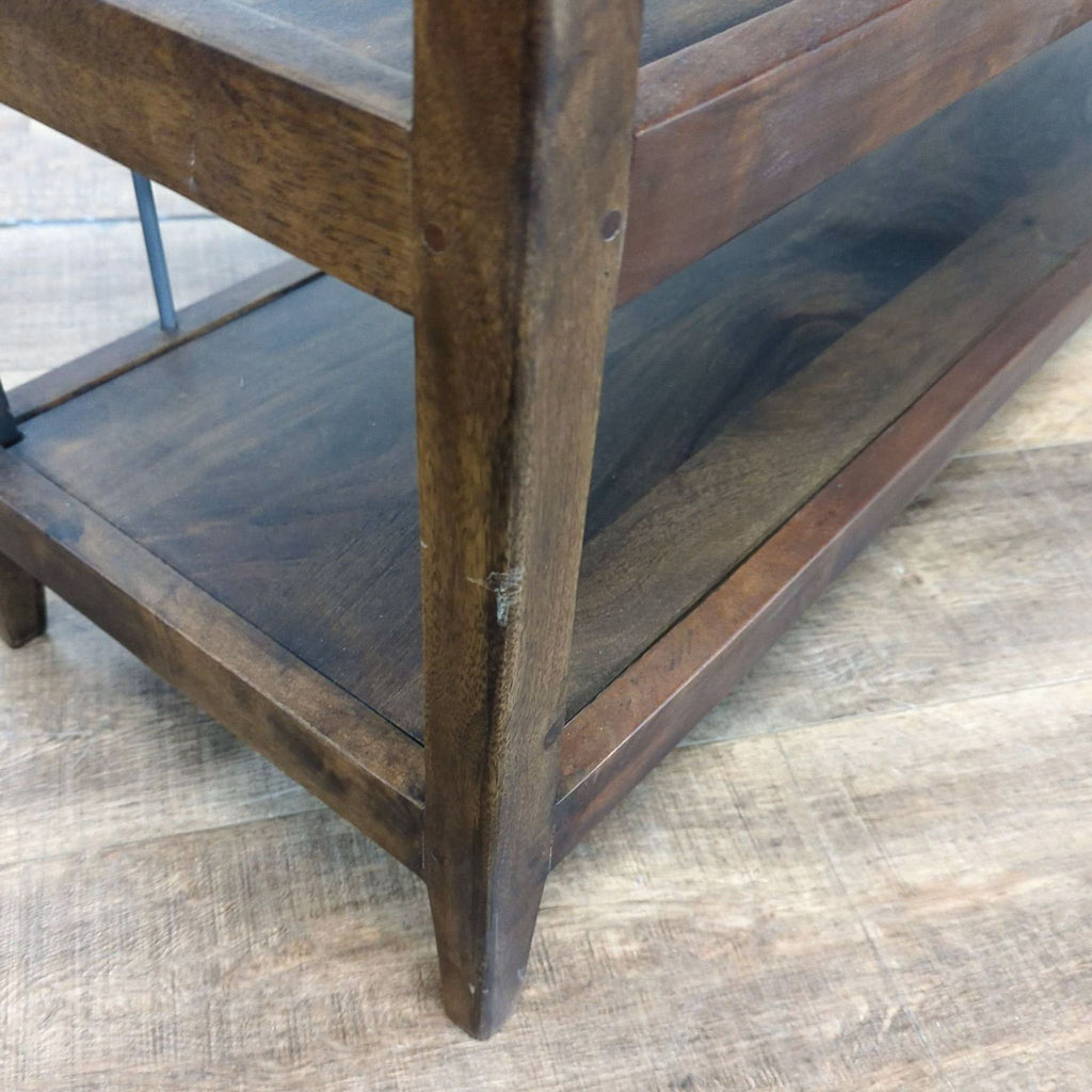 3. Detail of the table’s leg and lower shelf, highlighting the pecan finish and sturdy mango wood build.