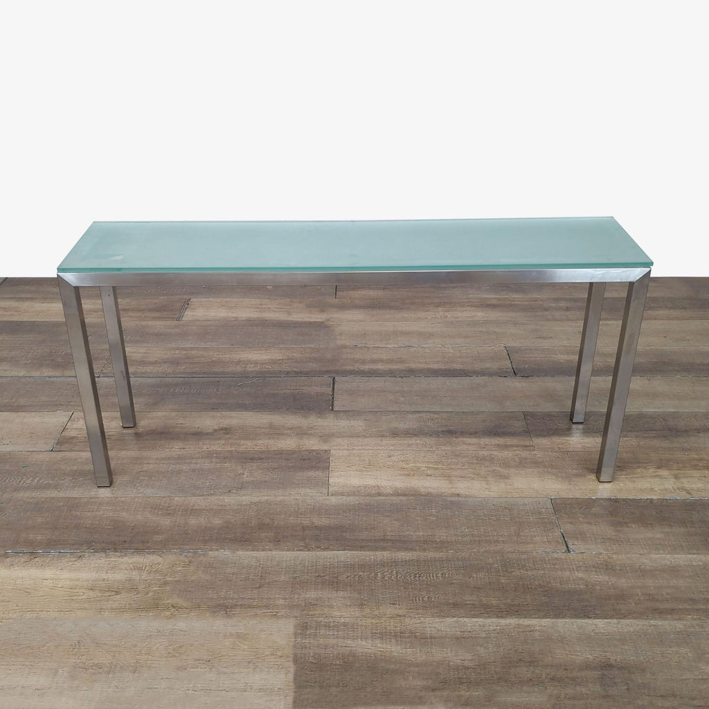 1. Reperch side and console table with chrome base and frosted glass top, shown on a wood floor.