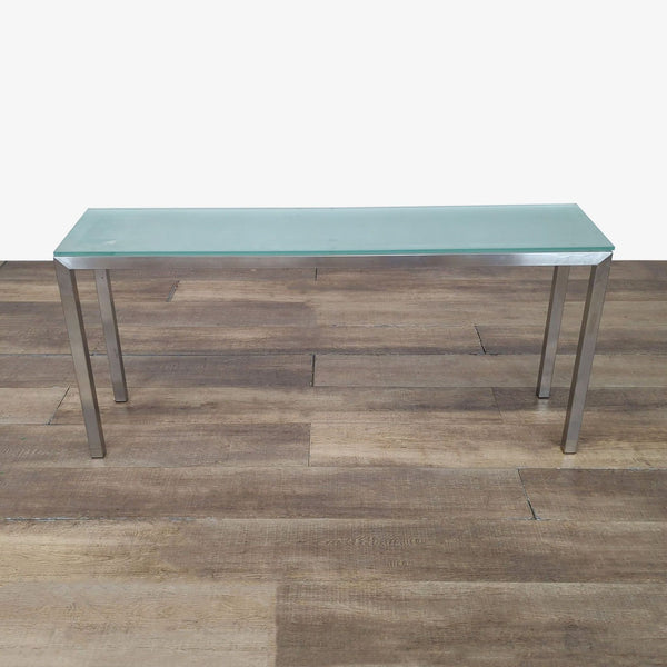 1. Reperch side and console table with chrome base and frosted glass top, shown on a wood floor.