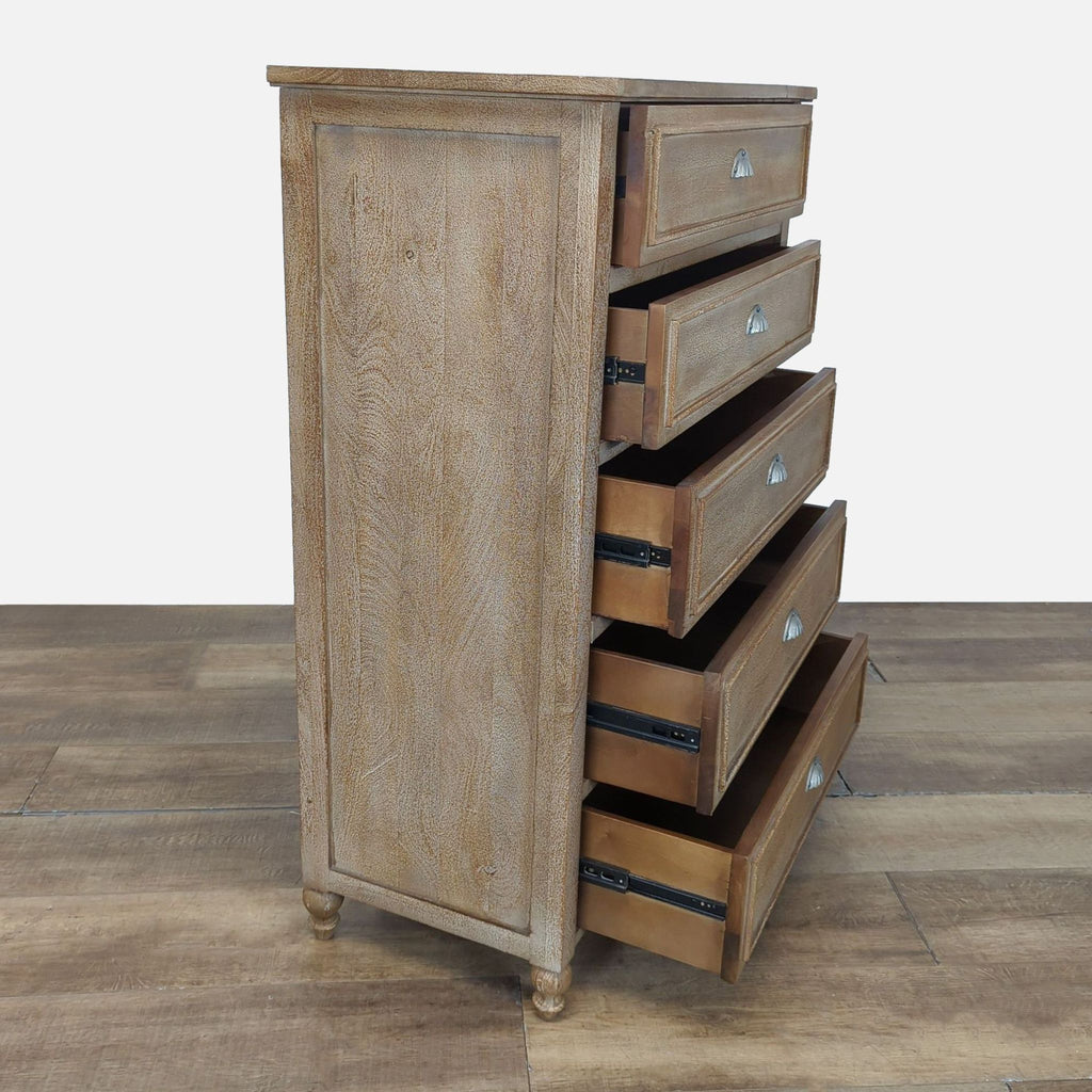 2. Side view of Pottery Barn dresser, showing five drawers on metal glides, all partially open.