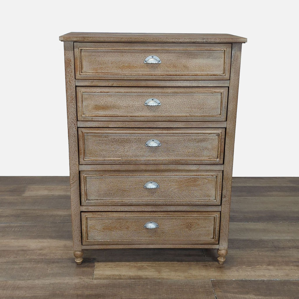 1. Pottery Barn dresser with five paneled drawers, each with a silver cup pull, on wood flooring.