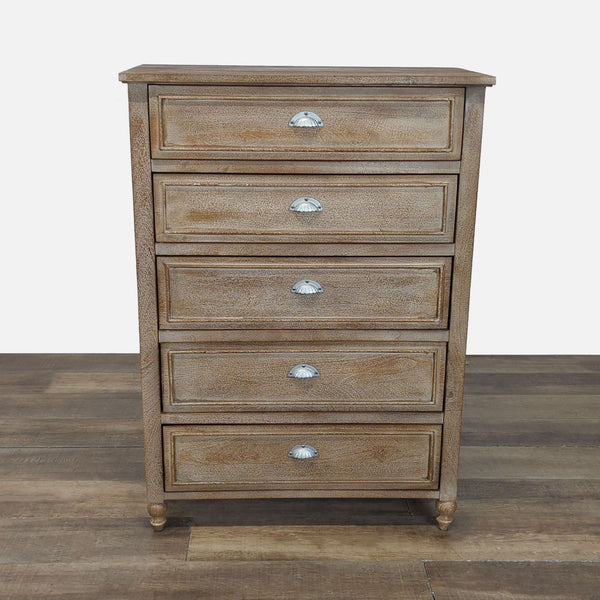 1. Pottery Barn dresser with five paneled drawers, each with a silver cup pull, on wood flooring.