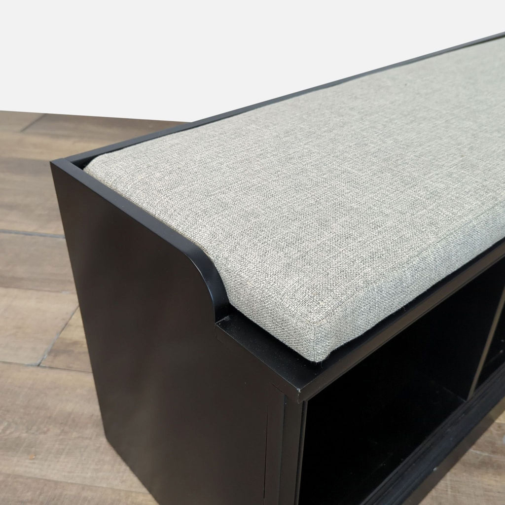 2. Close-up of Pottery Barn bench showing textured light cushion and black poplar wood frame detail.