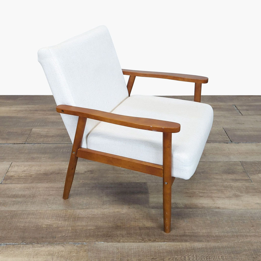 2. Angled side view showing the wooden arms and sleek white cushions of a Home Artisan lounge chair.