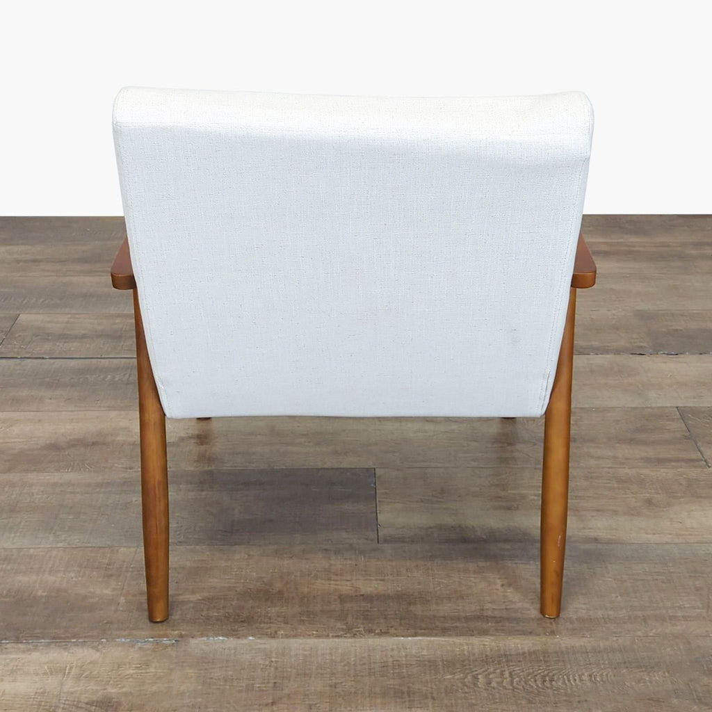 3. Rear view of the Home Artisan lounge chair showcasing the white upholstered back and wooden legs.