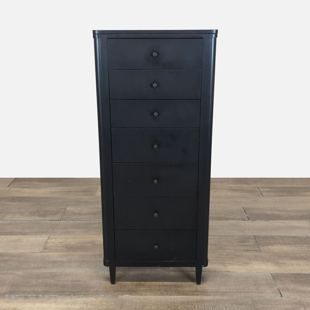 1. Tall black wood chest with 7 drawers, part of Crate and Barrel dresser collection, shown on wood floor.