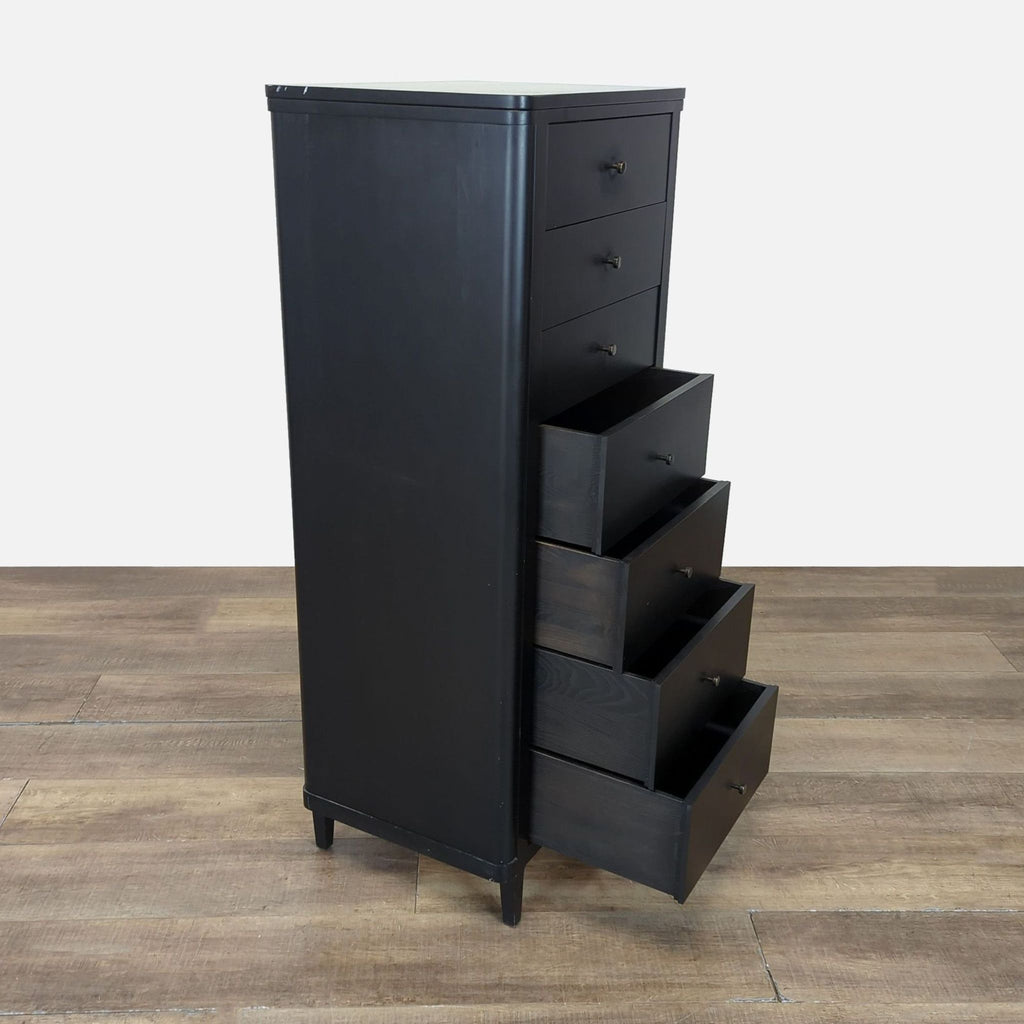 2. Side view of Crate and Barrel black 7-drawer dresser, with multiple drawers partially open for display.