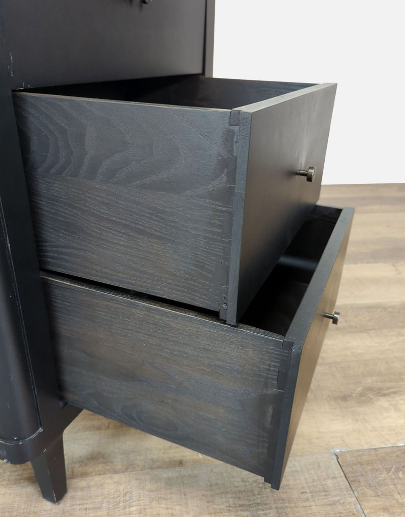 3. Close-up of two open drawers on a black wood Crate and Barrel dresser, showing texture and hardware.